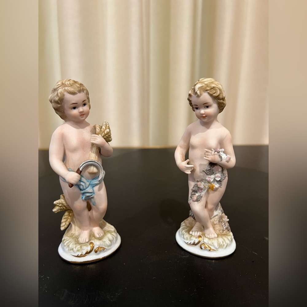 Pair of handpainted antique porcelain figurines.